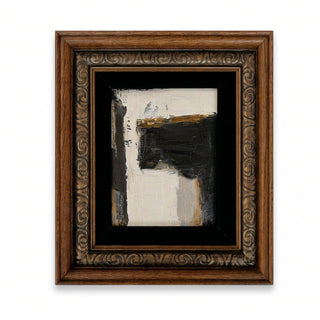 Framed abstract canvas art featuring textured black, white, and gold brushstrokes, set within an ornate carved brown wooden frame with a black mat.