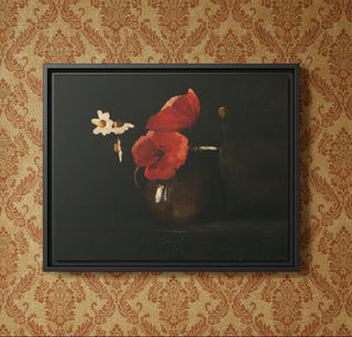Framed artwork of red flowers and a white flower in a dark setting