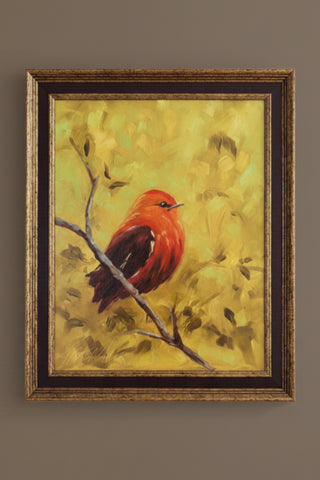 Framed painting of a red bird on a branch with a yellow background